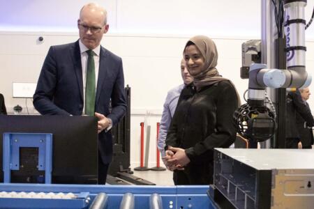 Minister Simon Coveney with Mark Dullea and Haleema Aziz