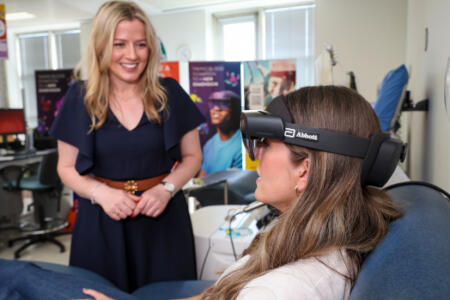 Nuala Haughian from Abbott introduces Caoimhe Byrne from Kildare to the Mixed Reality Intergalatica game at the National Blood Centre, Dublin