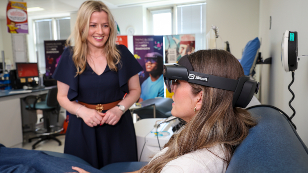 Nuala Haughian from Abbott introduces Caoimhe Byrne from Kildare to the Mixed Reality Intergalatica game at the National Blood Centre, Dublin