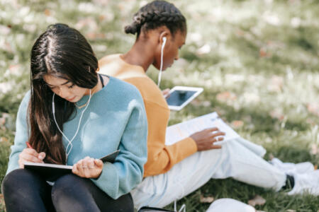 Students with books and a tablet